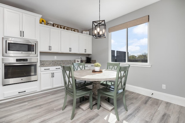 3887 N Condor Ct, Sanger, CA 93657 - dining space with a chandelier and light wood-style floors
