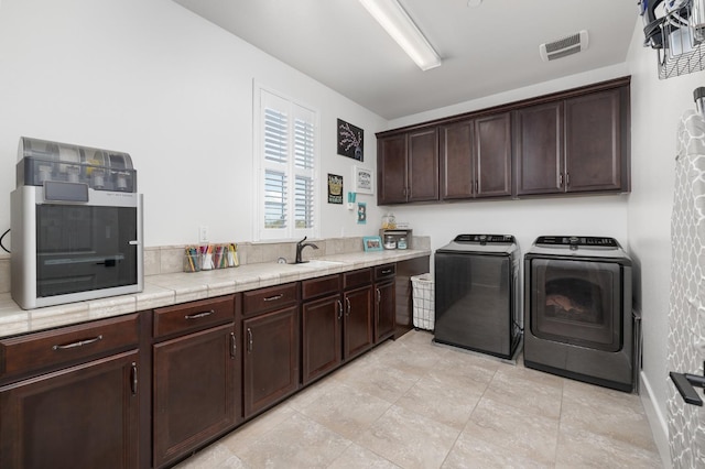 3887 N Condor Ct, Sanger, CA 93657 - laundry room featuring washing machine and dryer and cabinet space