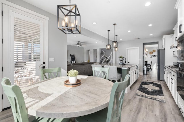3887 N Condor Ct, Sanger, CA 93657 - dining area featuring a ceiling fan, recessed lighting, a chandelier, and light wood-type flooring