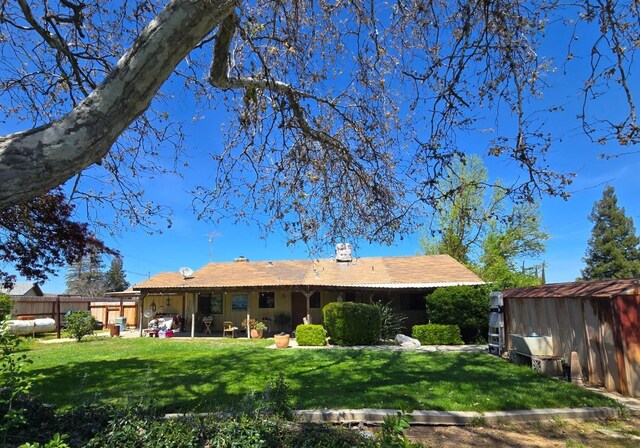 26174 Haley Way, Madera, CA 93638 - rear view of property featuring a patio, a storage shed, an outbuilding, a yard, and fence