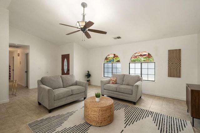 living area featuring vaulted ceiling, a ceiling fan, light tile patterned floors, baseboards, and visible vents