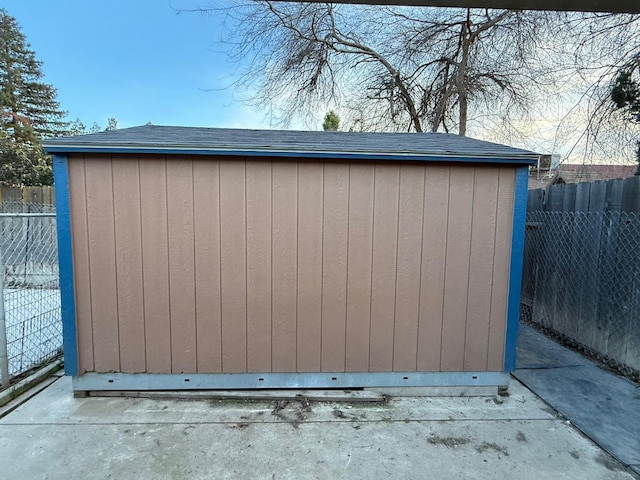 view of shed featuring fence