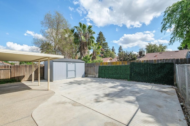 view of patio / terrace featuring a fenced backyard, an outbuilding, and a storage shed