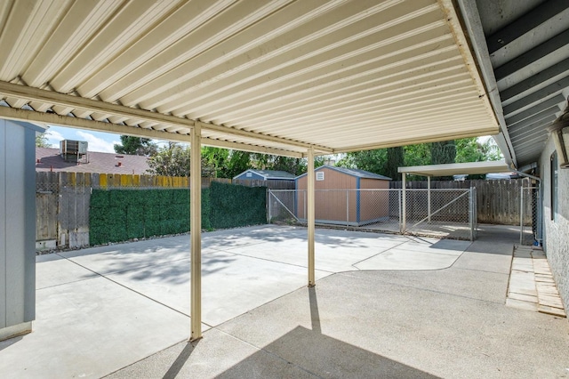 view of patio / terrace featuring an outbuilding, a fenced backyard, and a storage shed