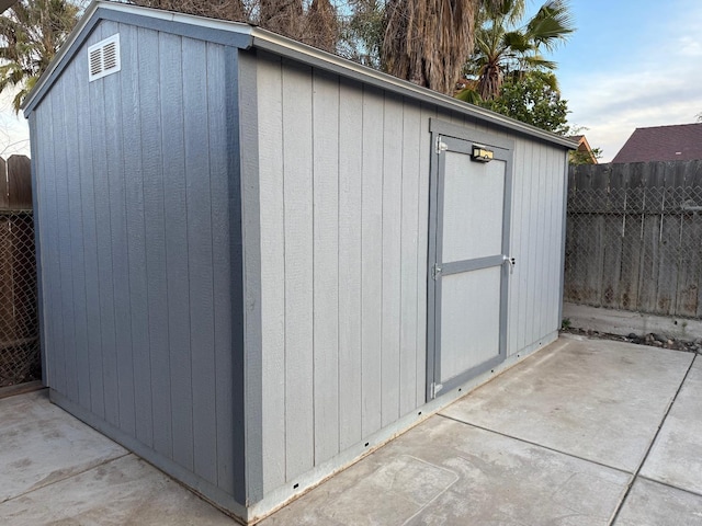 view of shed featuring a fenced backyard