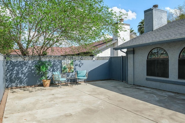view of patio featuring fence