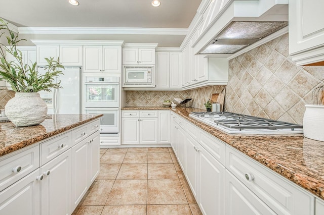 1643 E Shadow Glen Dr, Fresno, CA 93730 - kitchen featuring decorative backsplash, ornamental molding, white appliances, premium range hood, and white cabinetry