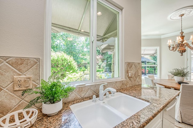 1643 E Shadow Glen Dr, Fresno, CA 93730 - interior space with decorative light fixtures, light stone countertops, dishwasher, a sink, and a notable chandelier