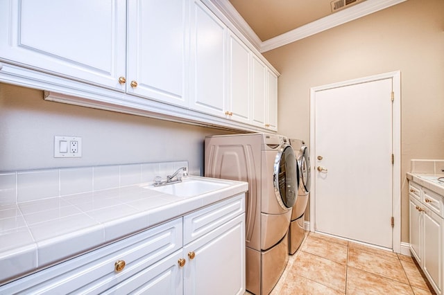 1643 E Shadow Glen Dr, Fresno, CA 93730 - laundry area featuring a sink, ornamental molding, cabinet space, and independent washer and dryer