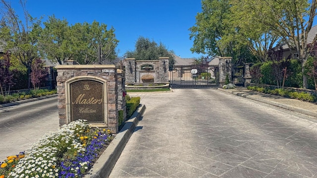 1643 E Shadow Glen Dr, Fresno, CA 93730 - view of road featuring a gate, a gated entry, and curbs