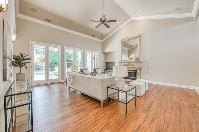 1643 E Shadow Glen Dr, Fresno, CA 93730 - living room featuring visible vents, a glass covered fireplace, french doors, a ceiling fan, and light wood-style flooring