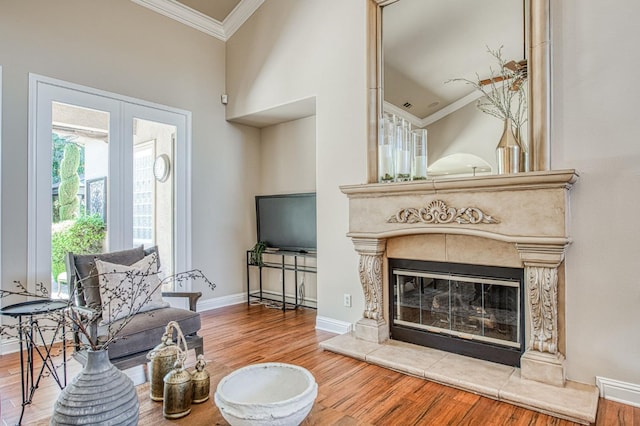 1643 E Shadow Glen Dr, Fresno, CA 93730 - living room featuring a tiled fireplace, baseboards, wood finished floors, visible vents, and ornamental molding