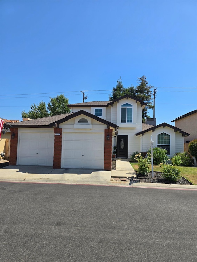 1295 E Athens Ave, Fresno, CA 93720 - traditional home featuring a garage, concrete driveway, and brick siding