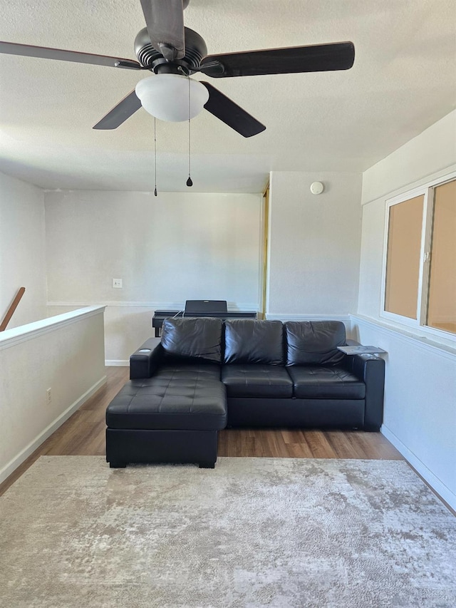1295 E Athens Ave, Fresno, CA 93720 - living area featuring wood finished floors, a textured ceiling, ceiling fan, and baseboards