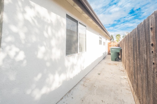 1295 E Athens Ave, Fresno, CA 93720 - view of property exterior with stucco siding and fence