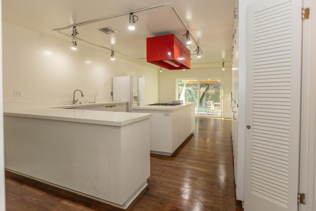1436 W Keats Ave, Fresno, CA 93711 - kitchen featuring white fridge with ice dispenser, track lighting, dark wood finished floors, a peninsula, and gas cooktop