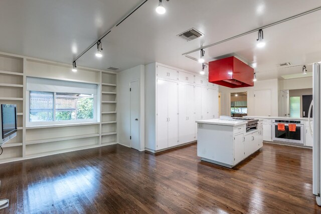1436 W Keats Ave, Fresno, CA 93711 - kitchen featuring stainless steel oven, built in features, a kitchen island, and dark wood-type flooring
