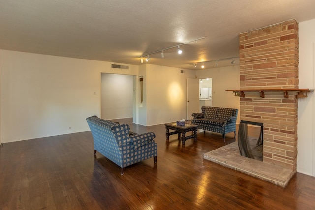 1436 W Keats Ave, Fresno, CA 93711 - living area featuring wood finished floors, a stone fireplace, and track lighting
