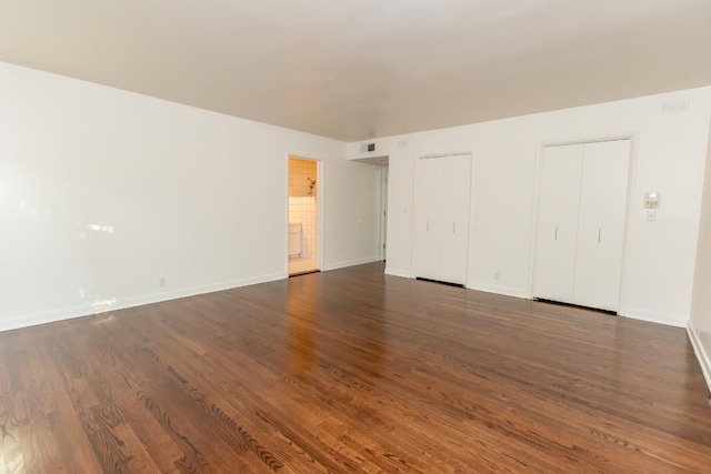 1436 W Keats Ave, Fresno, CA 93711 - unfurnished bedroom featuring two closets and dark wood-style flooring