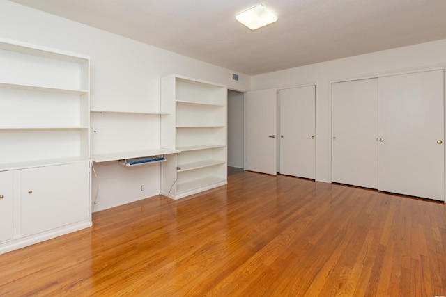 1436 W Keats Ave, Fresno, CA 93711 - unfurnished bedroom with light wood-style flooring and multiple closets
