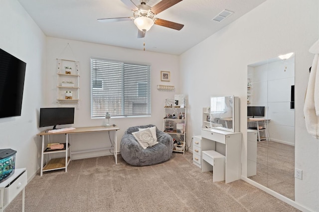 living area with ceiling fan, visible vents, and carpet floors