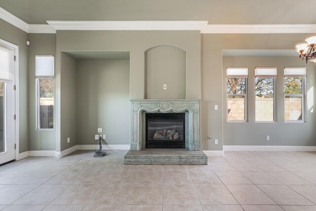 11 W Serena Ave, Clovis, CA 93619 - unfurnished living room featuring ornamental molding, a chandelier, tile patterned flooring, plenty of natural light, and a glass covered fireplace