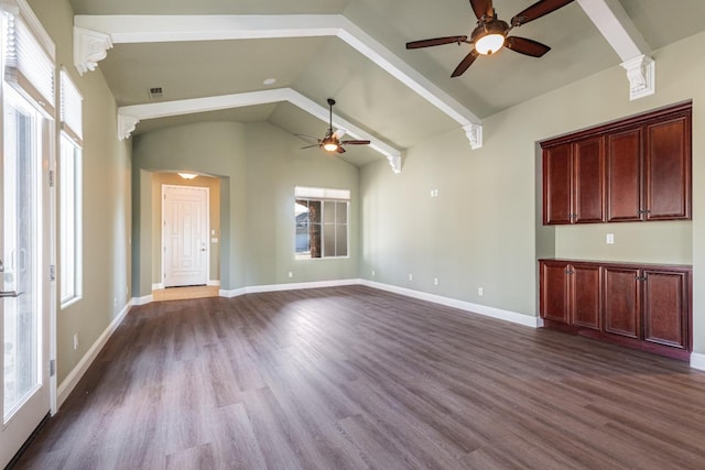 11 W Serena Ave, Clovis, CA 93619 - unfurnished living room with a ceiling fan, dark wood finished floors, vaulted ceiling, baseboards, and arched walkways