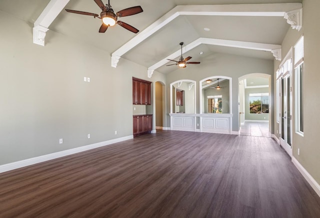 11 W Serena Ave, Clovis, CA 93619 - unfurnished living room featuring arched walkways, a ceiling fan, dark wood-style flooring, high vaulted ceiling, and beamed ceiling