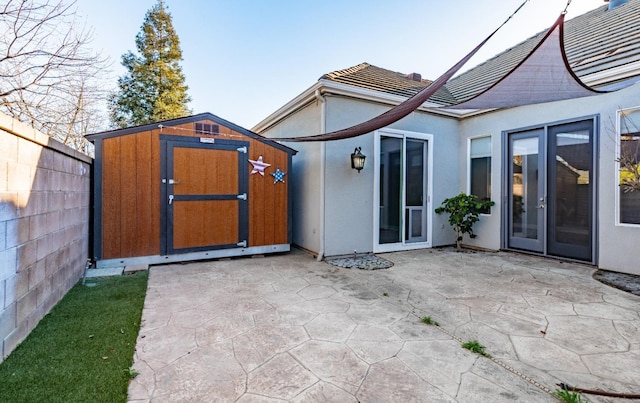 11 W Serena Ave, Clovis, CA 93619 - rear view of house featuring a patio area, a storage unit, stucco siding, and an outbuilding