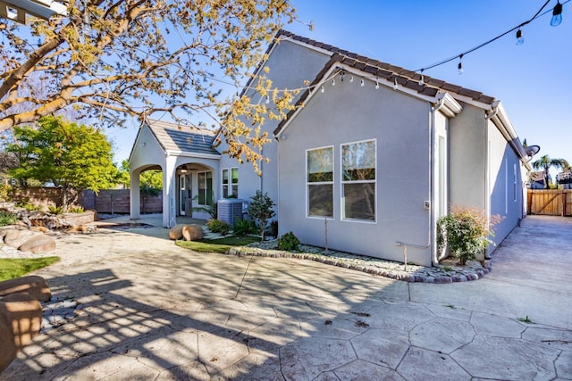 11 W Serena Ave, Clovis, CA 93619 - rear view of property with fence, central air condition unit, stucco siding, and a patio