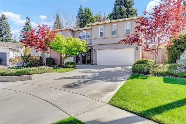 view of front of house with stucco siding, a garage, concrete driveway, and a front yard