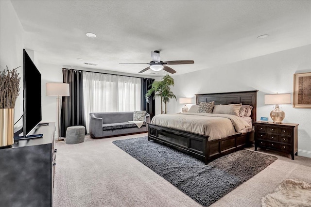 bedroom with a ceiling fan, carpet floors, baseboards, and visible vents
