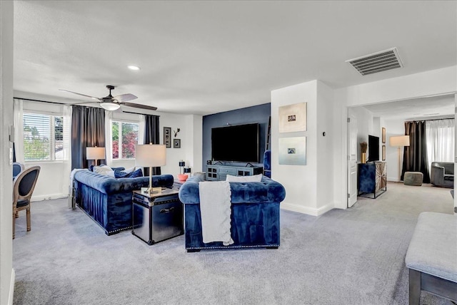 living room with baseboards, carpet flooring, ceiling fan, and visible vents