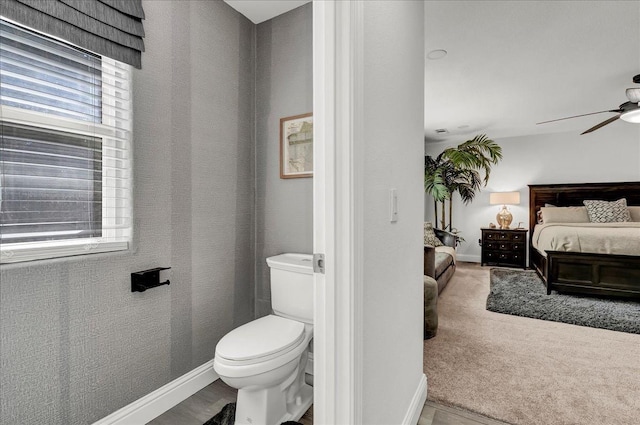 bathroom featuring baseboards, toilet, ensuite bath, and a ceiling fan