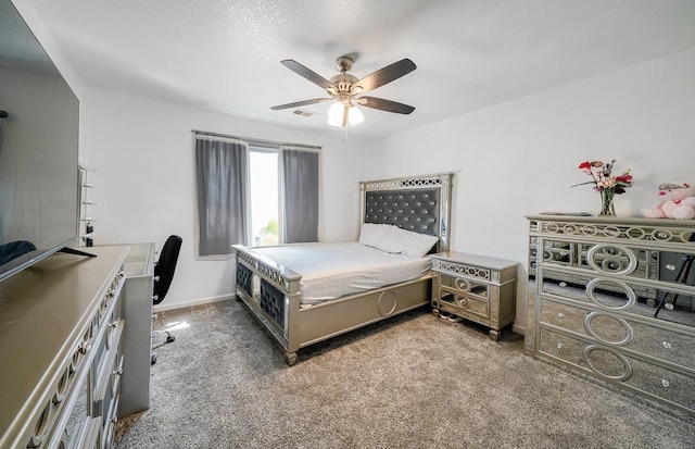 carpeted bedroom featuring a textured ceiling, baseboards, ceiling fan, and visible vents