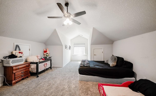 bedroom with lofted ceiling, ceiling fan, carpet flooring, and a textured ceiling