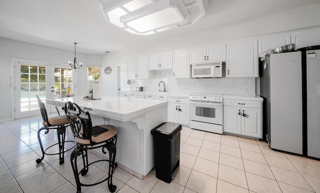 kitchen with french doors, white cabinets, light tile patterned flooring, and white appliances