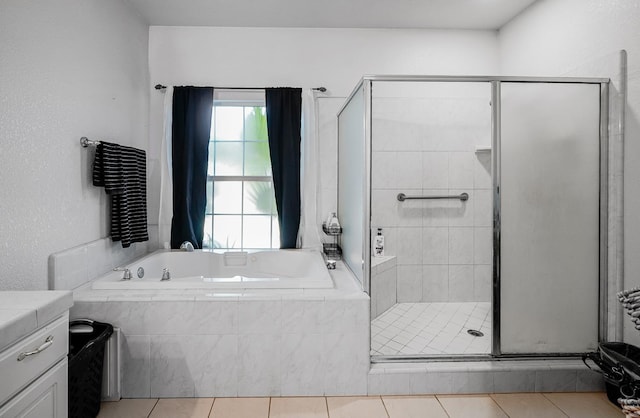 bathroom with tile patterned floors, a stall shower, and a bath