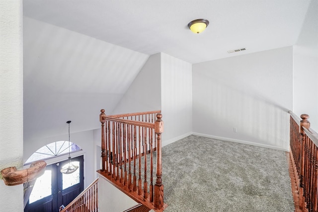 additional living space featuring carpet floors, baseboards, lofted ceiling, and visible vents