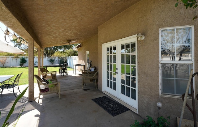 view of patio with a fenced backyard, outdoor dining area, and french doors