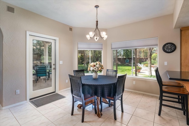 dining room featuring plenty of natural light, light tile patterned floors, a notable chandelier, and visible vents