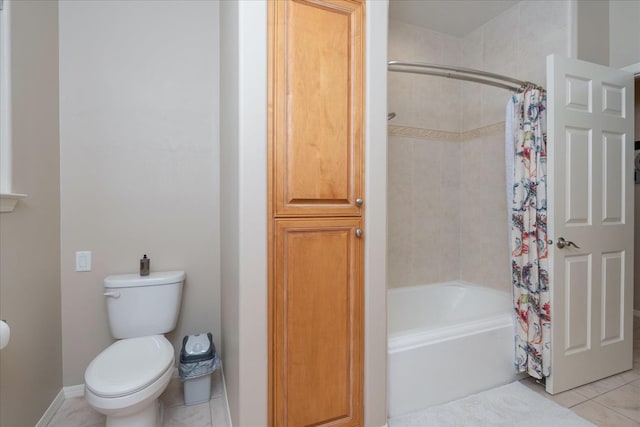 bathroom featuring tile patterned flooring, shower / bathtub combination with curtain, and toilet
