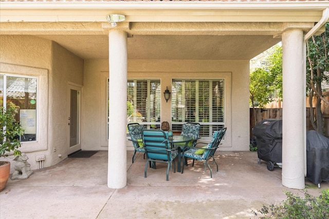 view of patio with fence and outdoor dining area