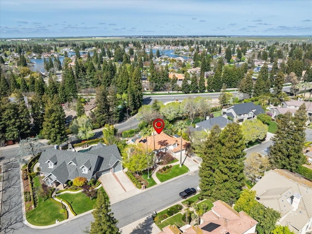 drone / aerial view featuring a water view and a residential view
