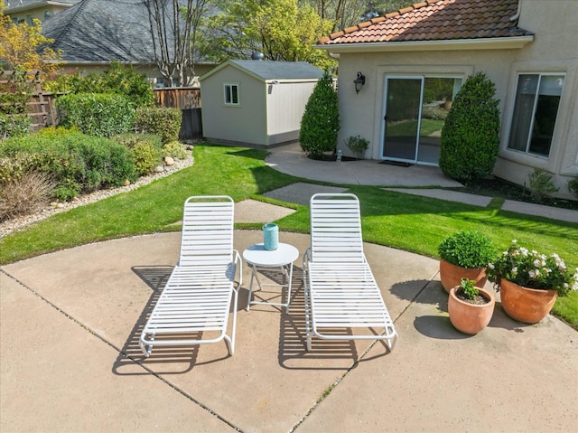 view of patio / terrace with fence and an outdoor structure