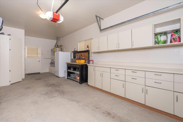 garage with strapped water heater and a garage door opener