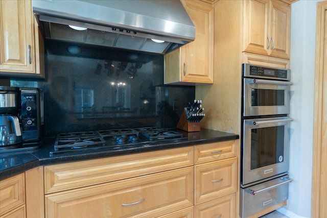 kitchen featuring exhaust hood, backsplash, double oven, black gas stovetop, and a warming drawer