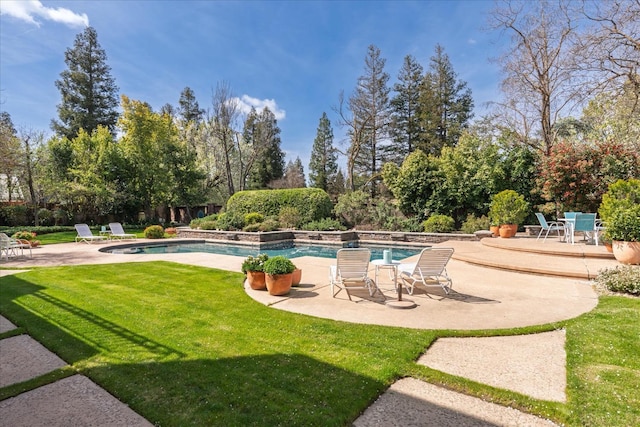 surrounding community featuring a yard, a patio area, and a pool
