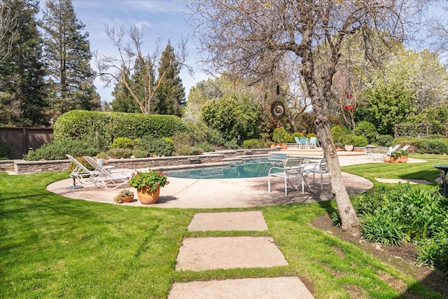 view of pool featuring a lawn, a patio area, fence, and a fenced in pool