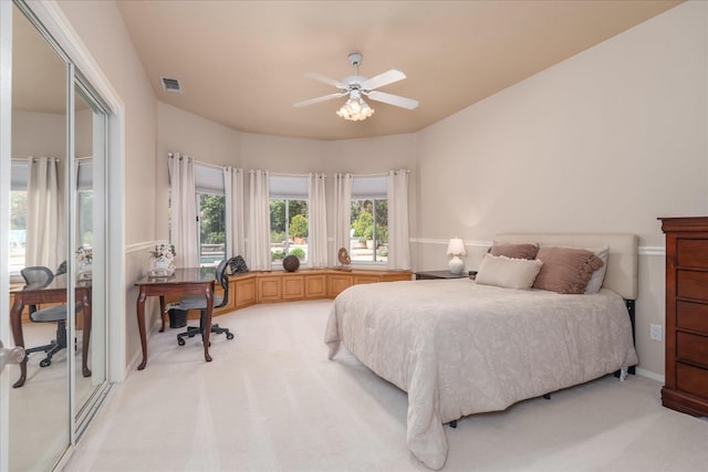 bedroom with visible vents, ceiling fan, and light colored carpet